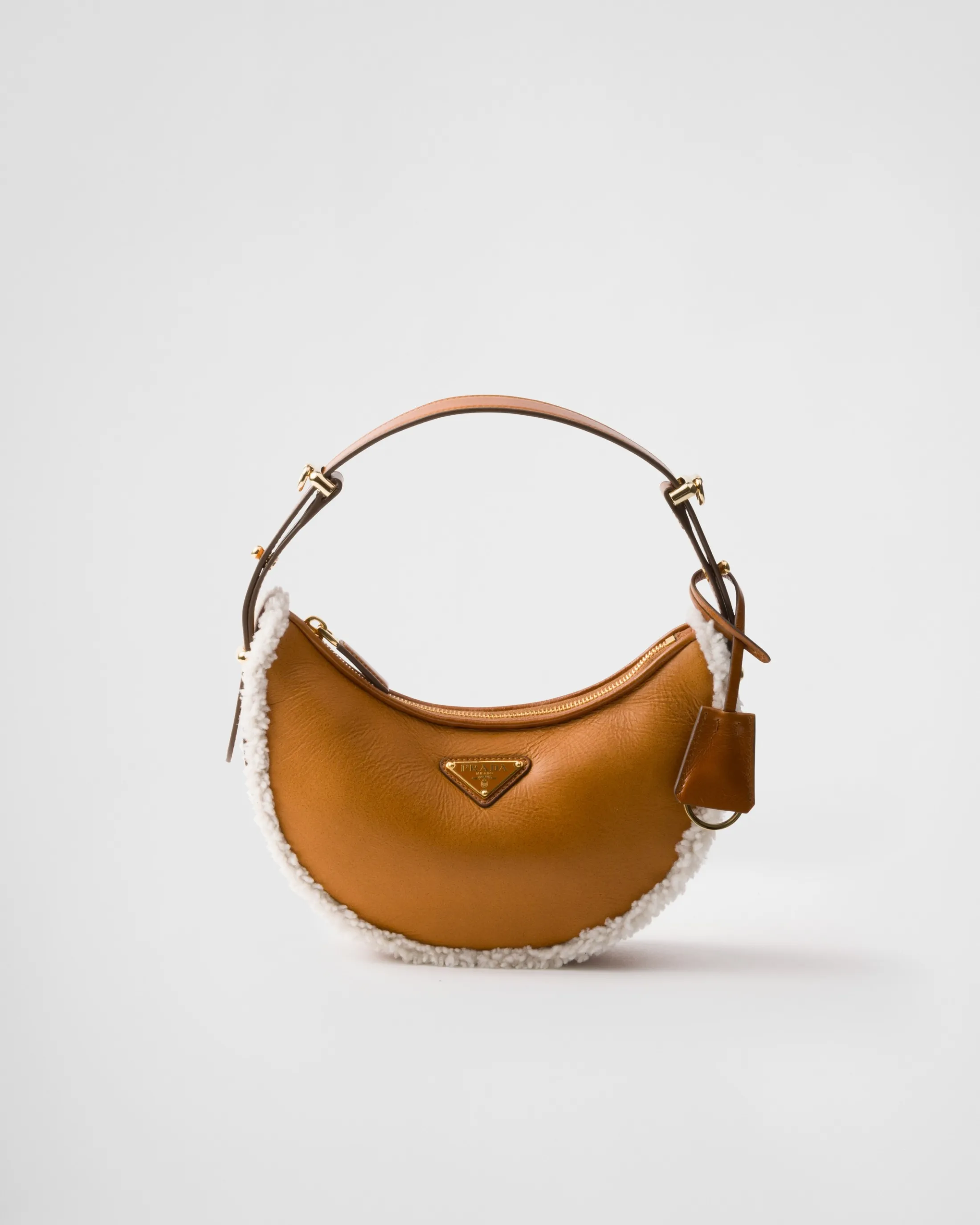 Prada Arqué small shearling shoulder bag Cognac/natural Shop